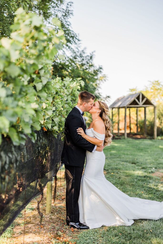 Newlyweds kiss at The Vineyards at Aquebogue